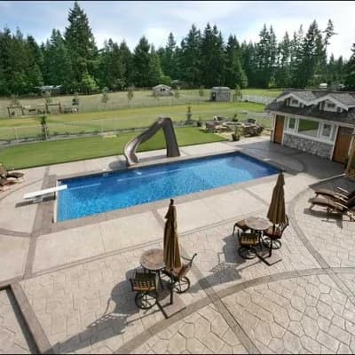Stamped concrete pool deck in Puyallup, WA with water-slide and stamped borders