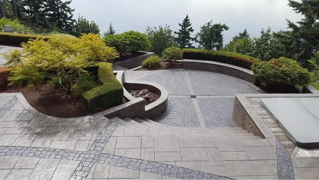 Elevated view of the terraced patio, highlighting the flowing lines and integrated planters and steps.