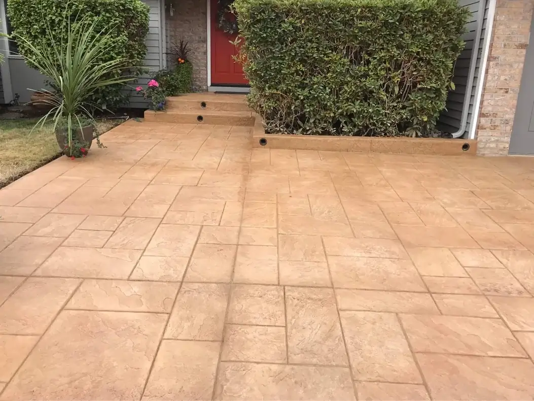 Stamped concrete walkway in Tacoma leading to integrated steps with built-in lighting fixtures at the front door.