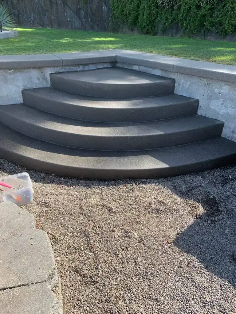High-angle view of the four-tiered curved concrete steps showing their symmetrical fan shape.