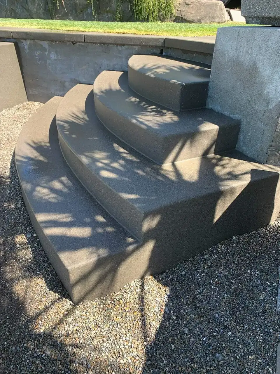 Side profile of the custom-formed curved concrete steps, highlighting the depth of each tread.