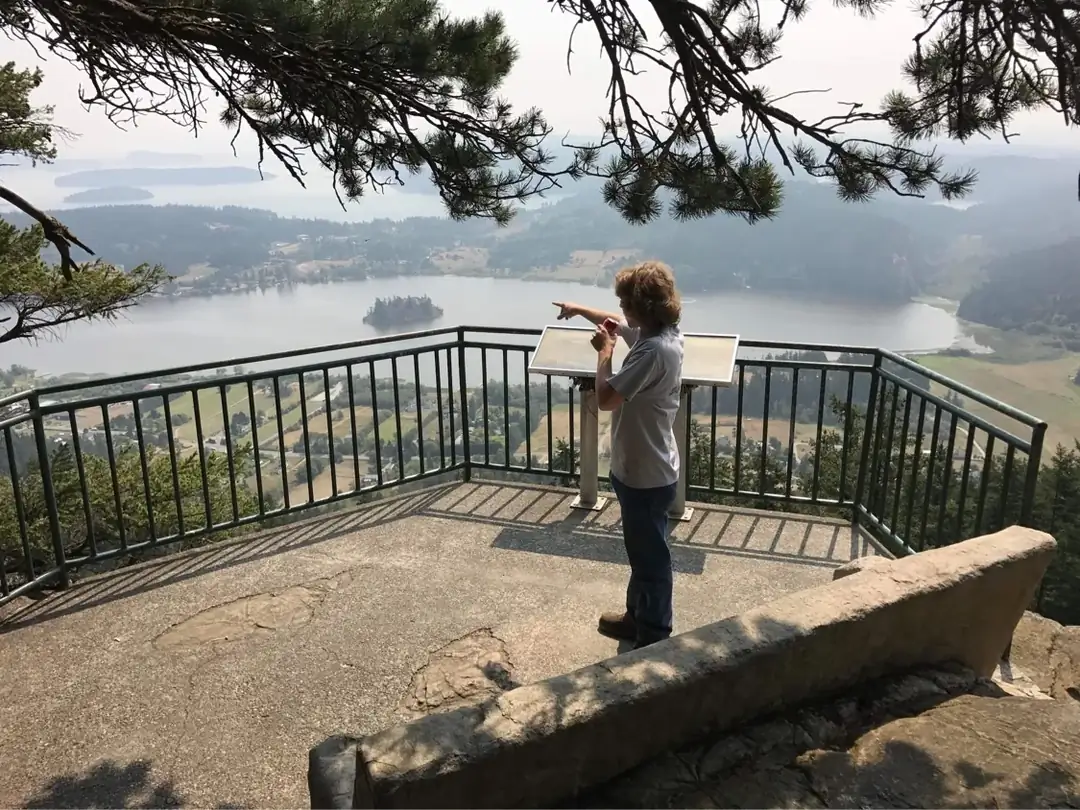 A visitor enjoying the view from the scenic overlook next to the custom concrete bench installation.