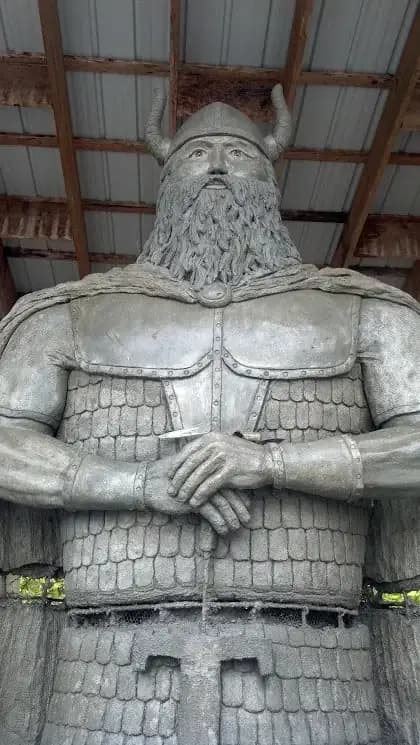 Close-up of a custom concrete warrior sculpture in Puyallup, showing the detailed texture of the beard and armor.