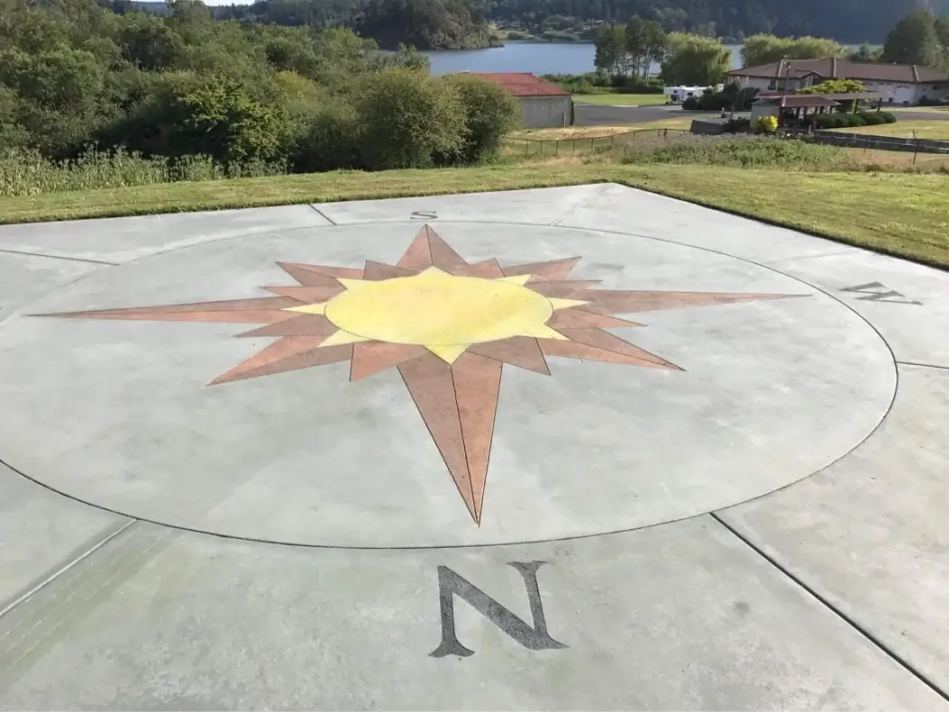 A detailed look at the north-facing point of a stained compass rose on a custom concrete slab in Bellevue.