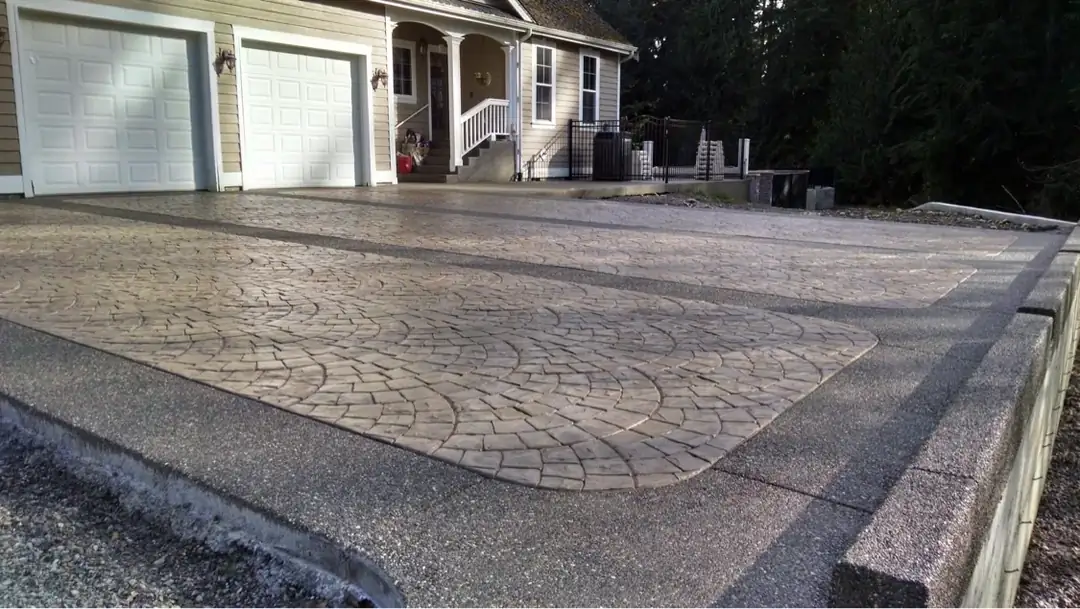 Wide angle view of the completed stamped concrete driveway with its aggregate border and matching curb.