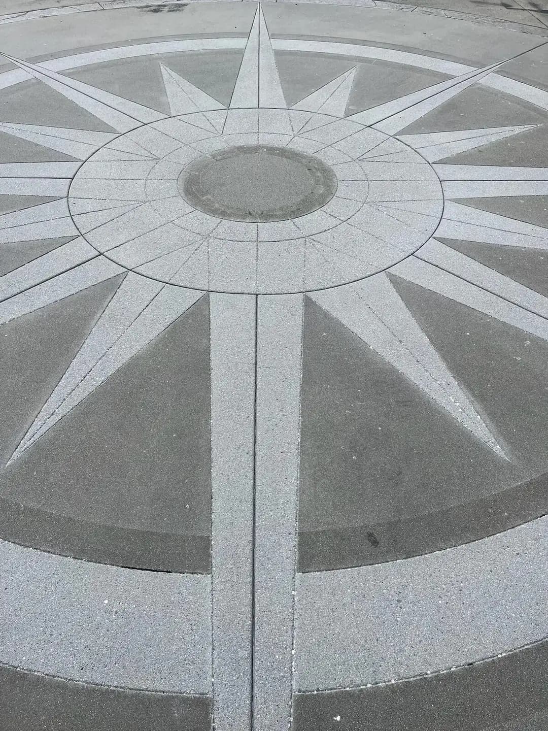 Overhead shot of the two-tone finish on the concrete compass rose, showing the contrast in texture and color.