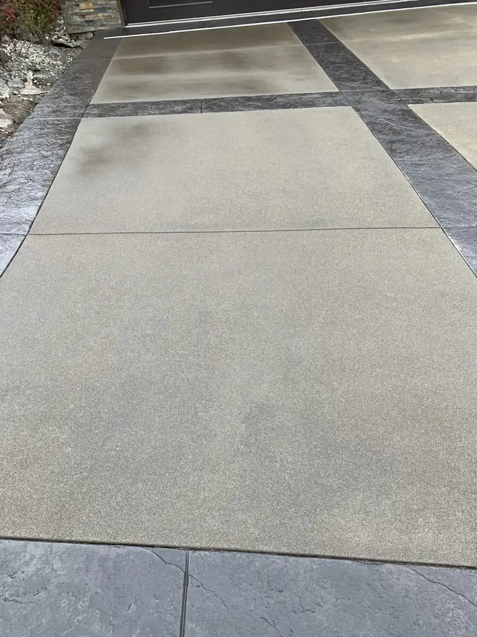 Close-up of the sand-finish concrete surface, highlighting the fine texture and precise saw-cut lines.