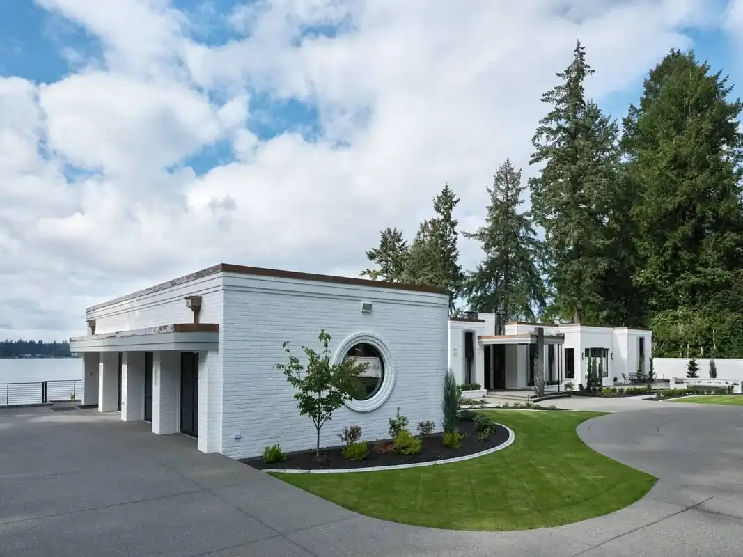 View of the exposed aggregate driveway and walkway leading to a modern garage and entryway in Bellevue, WA.