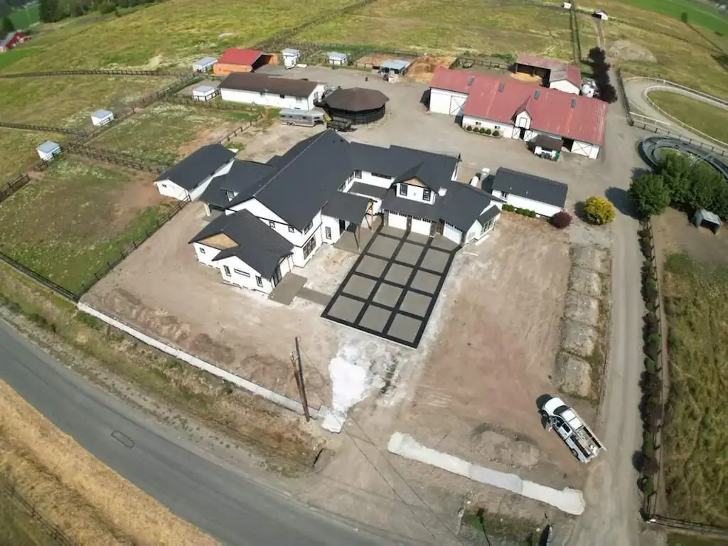 Aerial drone shot of the entire property in Puyallup, highlighting the scale of the new concrete driveway.