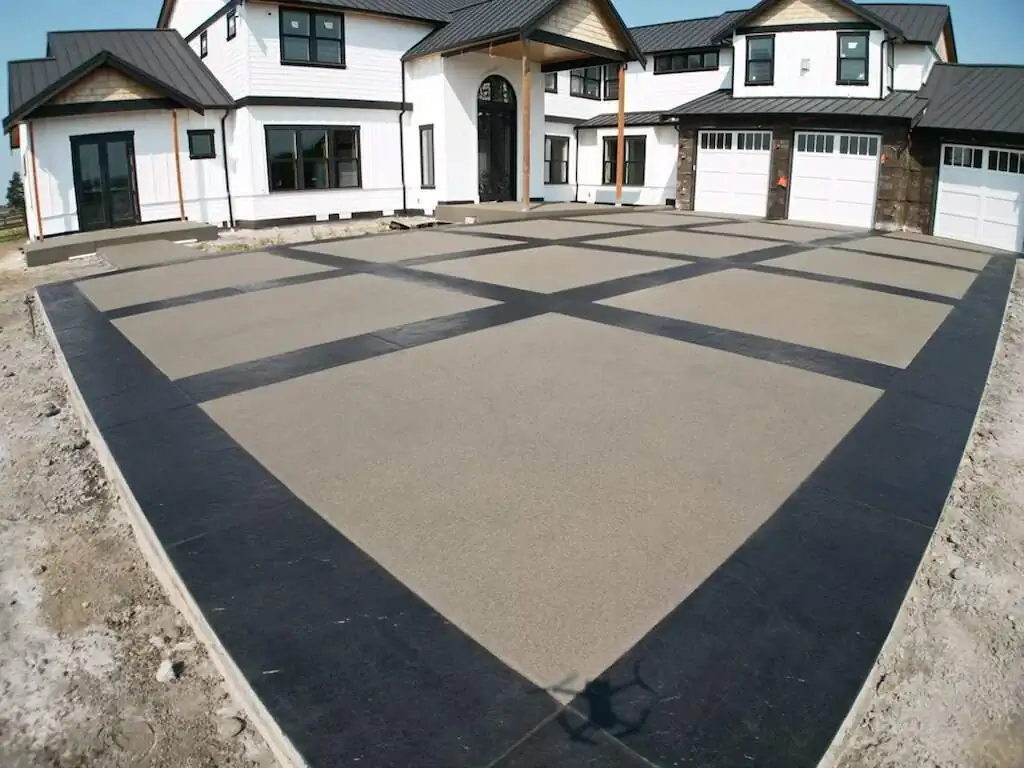 Low angle view of the driveway's contrasting finishes, with a stamped border and sand finish interior.