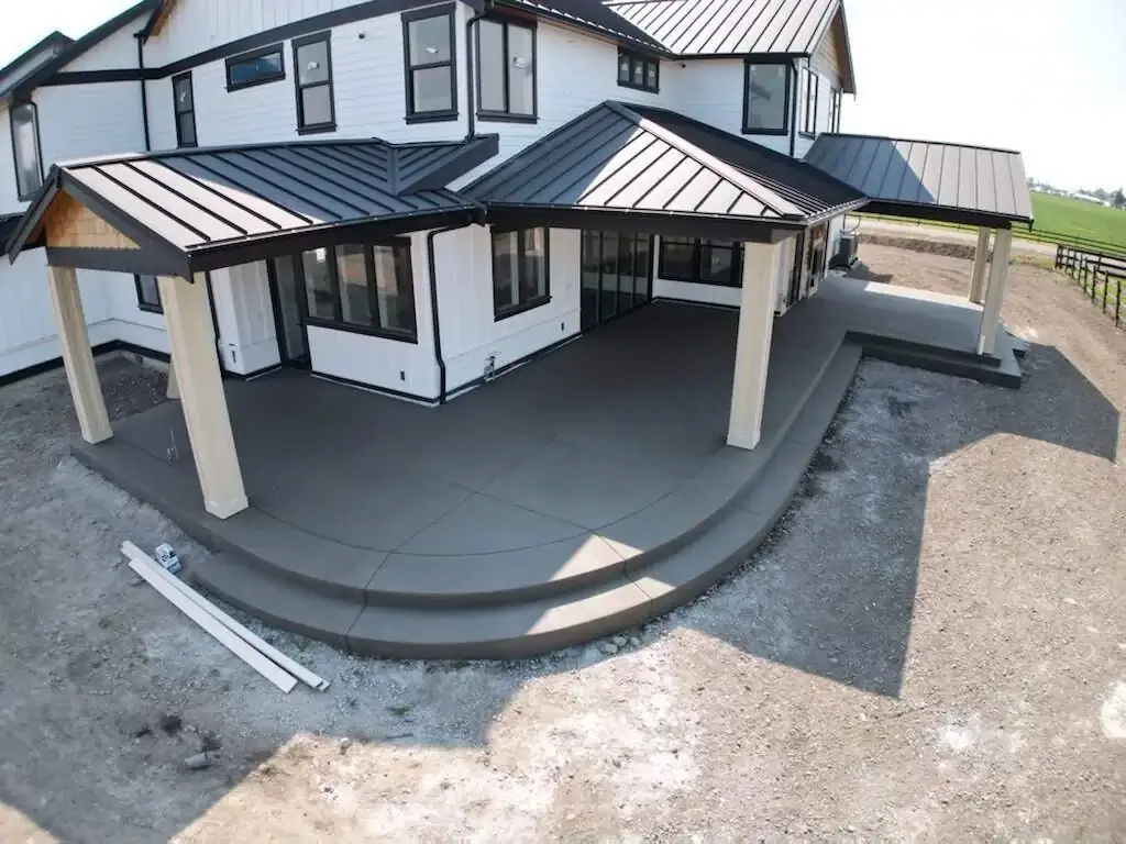 Elevated view of the sand finish back patio and multi-level steps under a covered porch area.