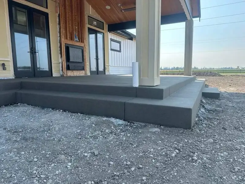 Close-up of the sand finish concrete steps at the front porch, showing the clean edges and consistent color.