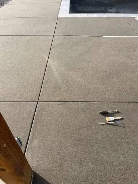 A close-up shot of the sand finish texture and the crisp, clean lines of the saw-cut control joints.