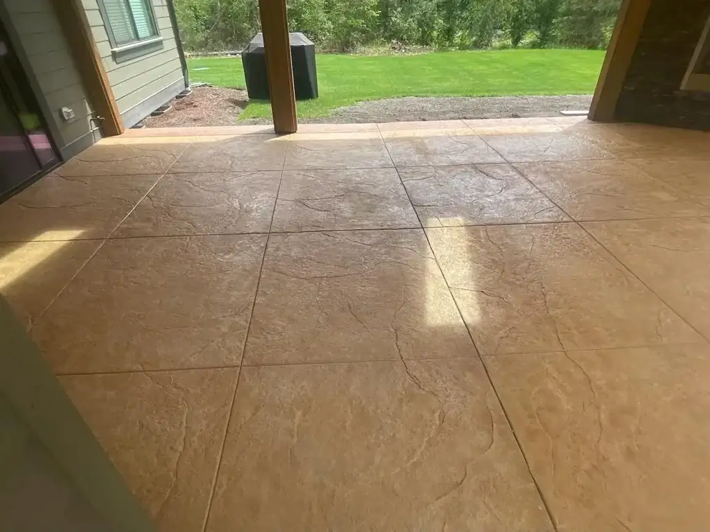 The raised concrete beam surrounding the hot tub, finished with a smooth surface for informal seating.