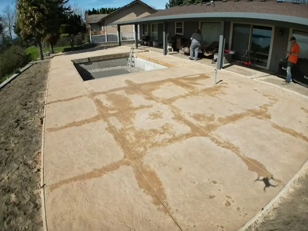 The textured surface of the stamped concrete provides a safe, non-slip area around the wet pool environment.