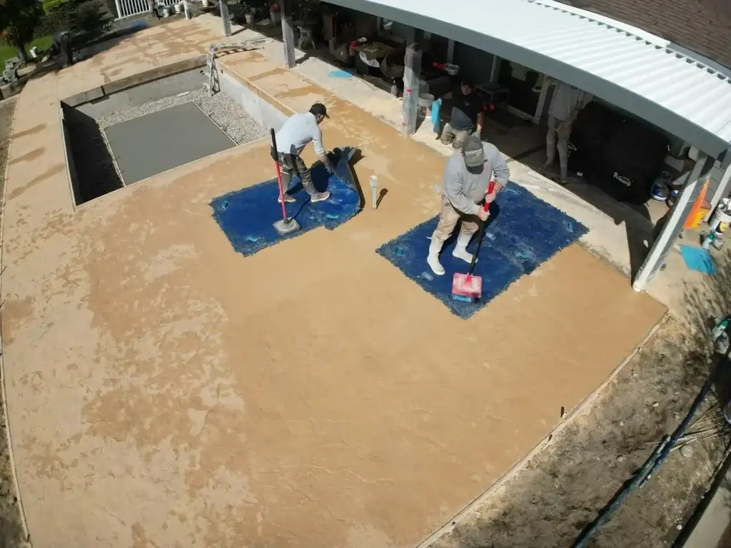 Detail of the stamped concrete patio adjoining the brick veneer base of the integrated hot tub.