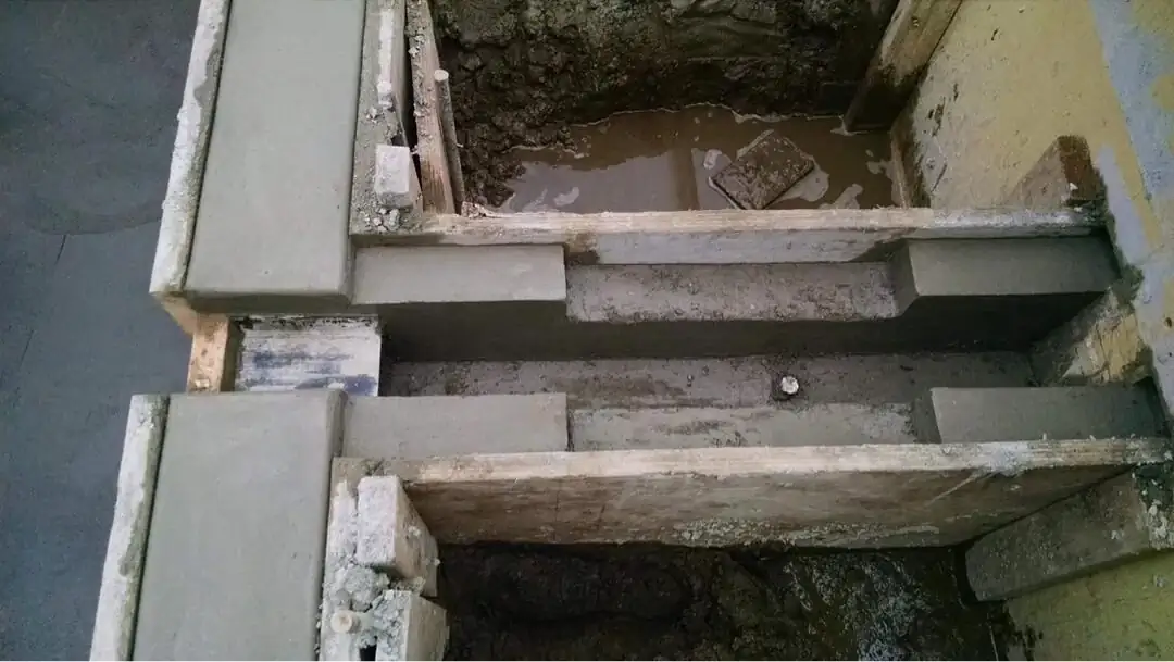 Overhead view of complex formwork for tiered concrete steps during the construction phase.