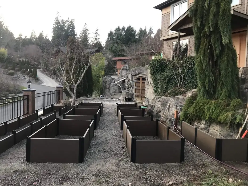 Wide angle shot of the complete set of exposed aggregate garden boxes set on a terraced landscape.