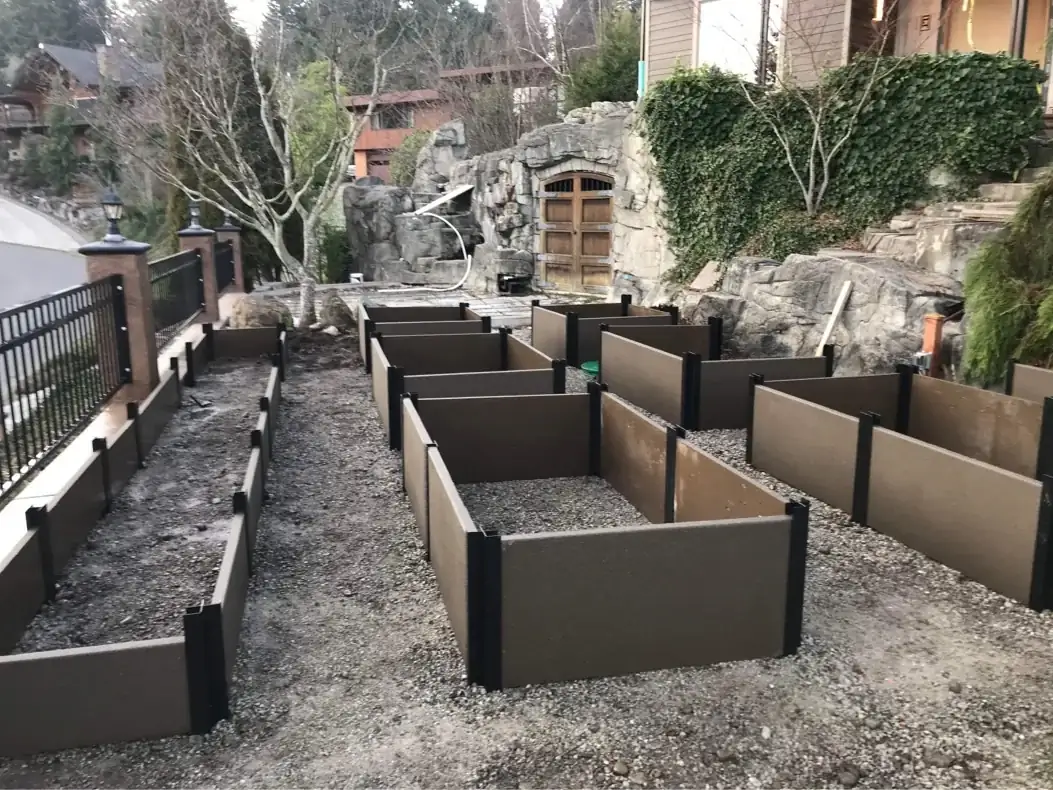 The arrangement of custom concrete planter boxes creating pathways for a future terraced garden.
