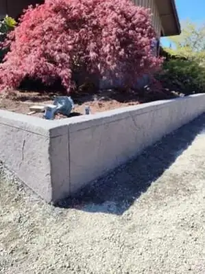 A sharp, mitered corner on a textured concrete retaining wall, highlighting the precise formwork.