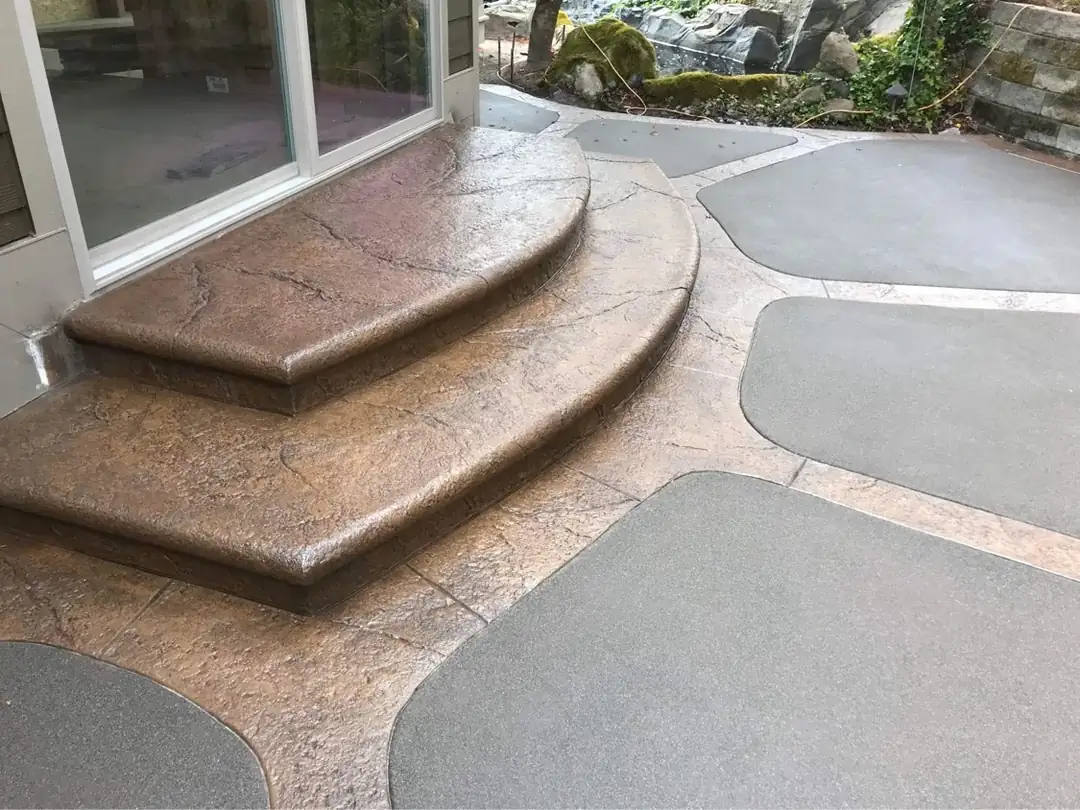 Close-up of the bullnose-edged, stamped concrete steps on a custom patio installation in Puyallup.