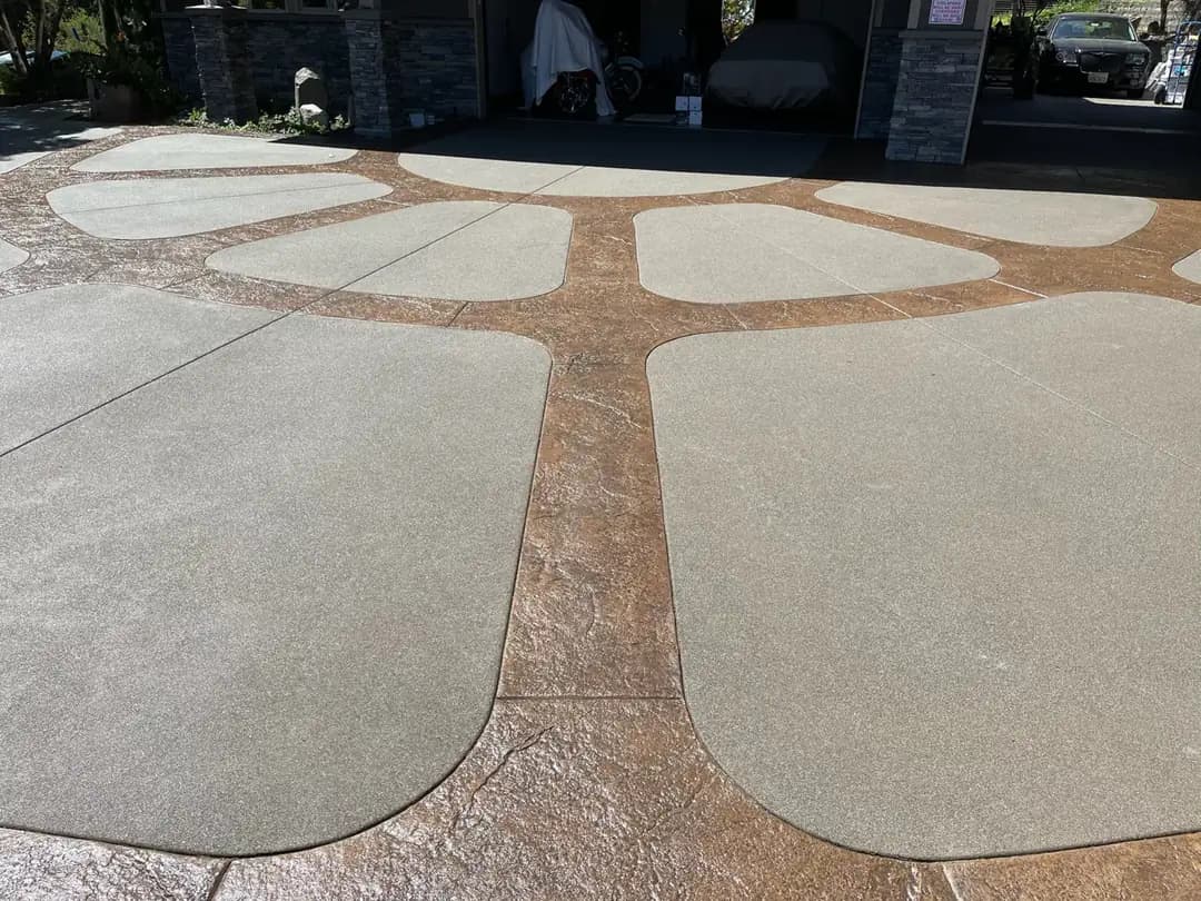 Looking down the driveway towards the garage, highlighting the central stamped inlay.