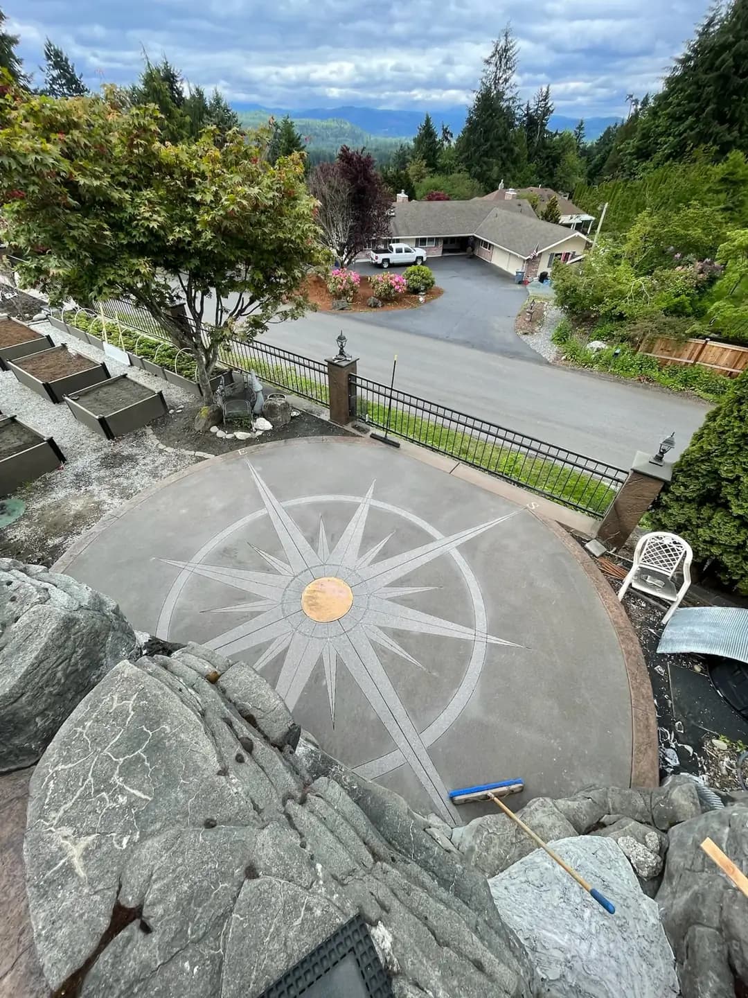Overhead view of the unsealed exposed aggregate compass patio in Puyallup, showing the raw color and texture.