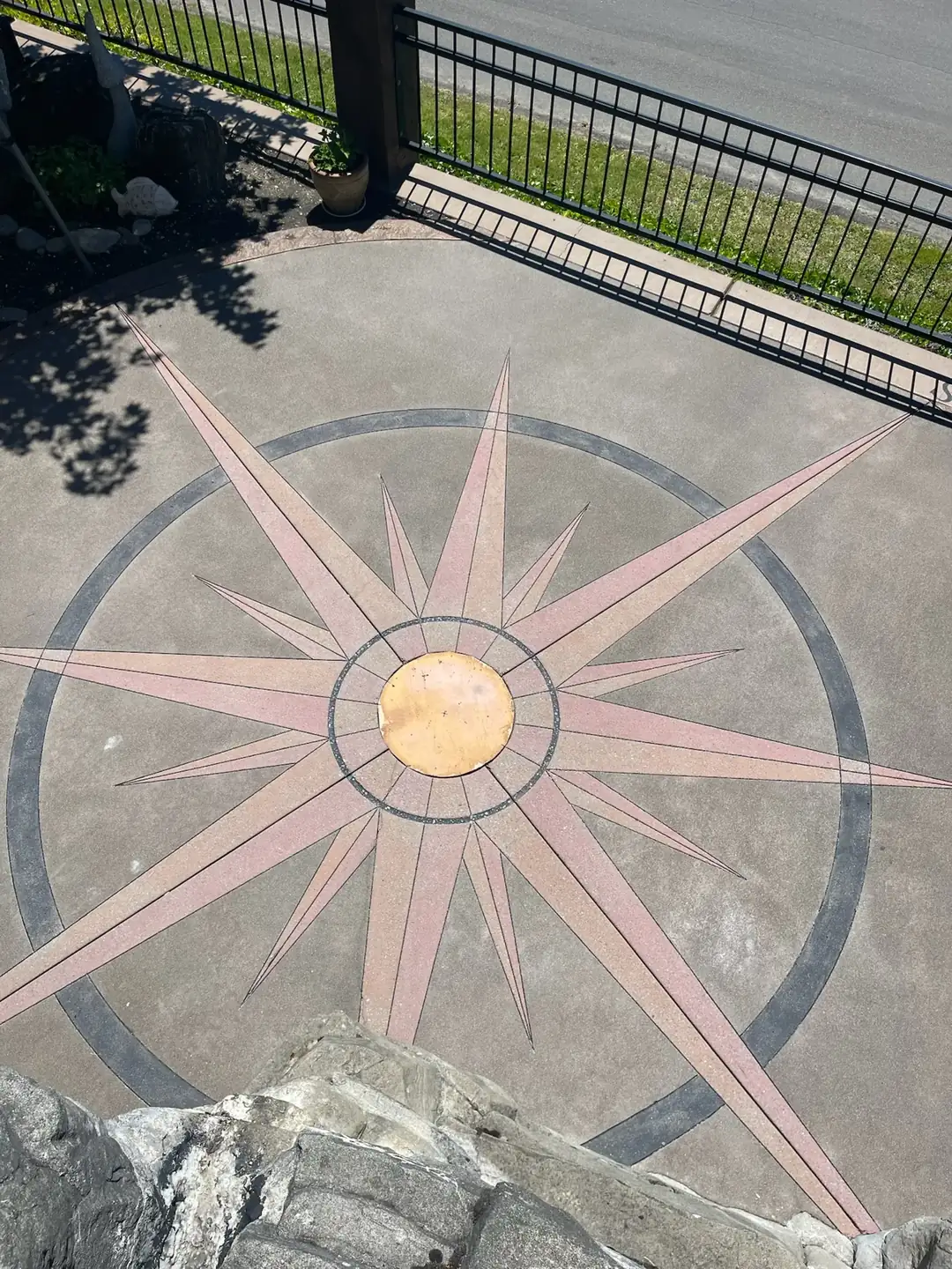 Top-down perspective of the sealed compass rose, showing the balanced and symmetrical concrete artwork.