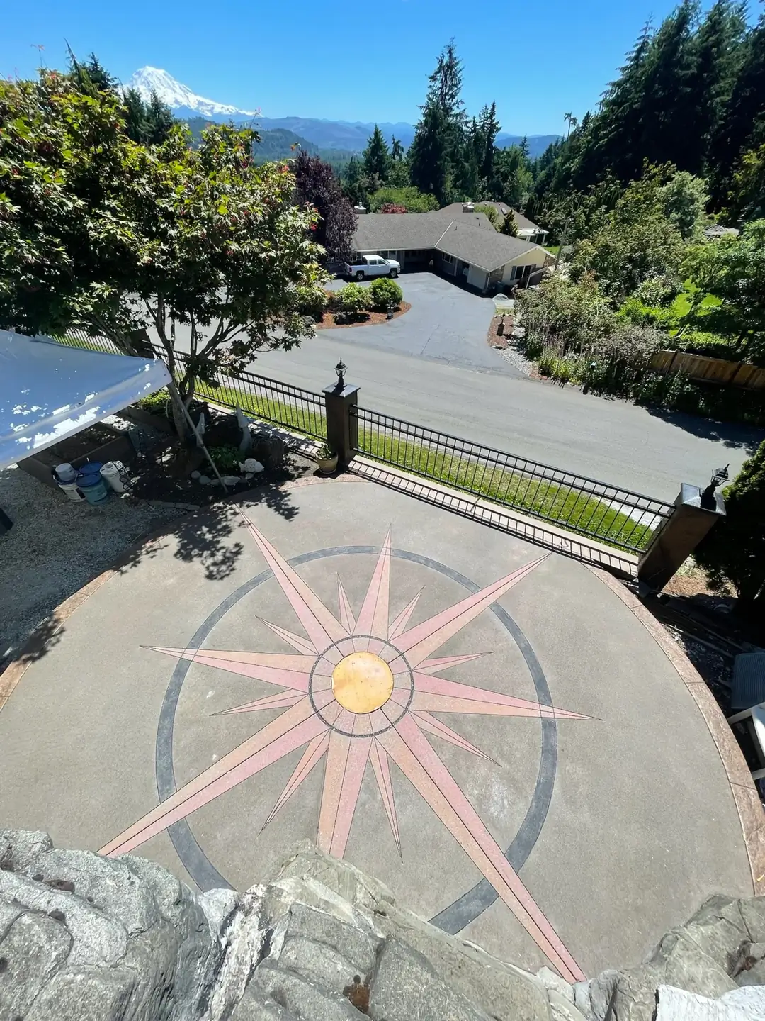 Wide overhead view of the circular patio with a mountain visible in the background, showing its setting.