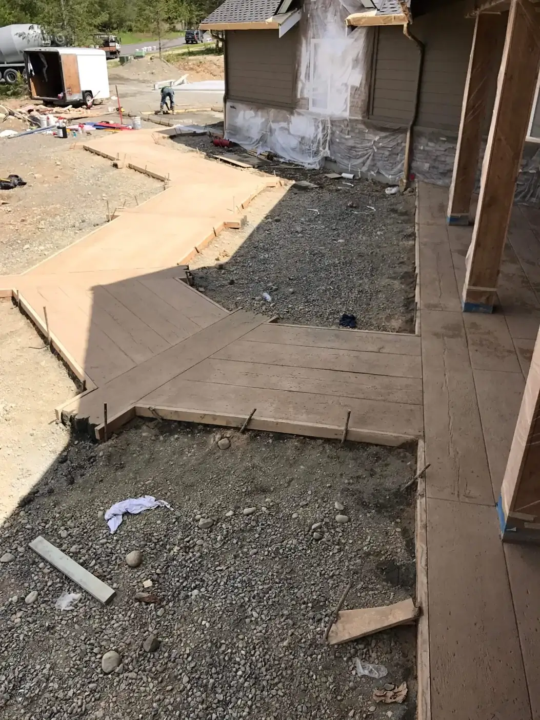 Overhead view of the walkway during construction, showing the fresh concrete pour and initial formwork.