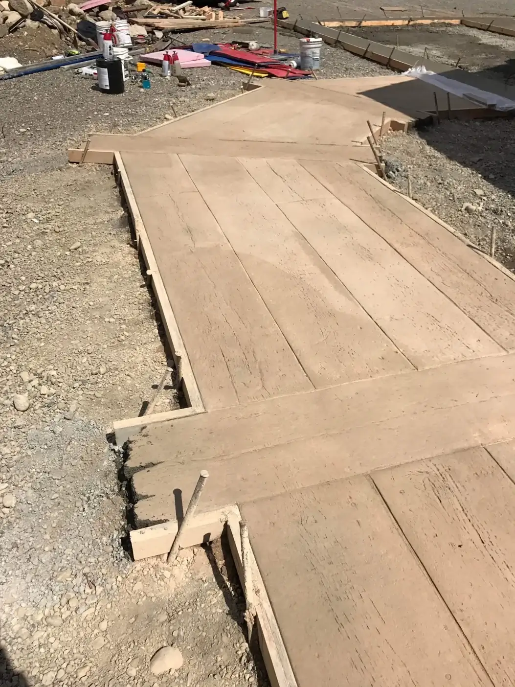 Formwork in place for the intersecting planks of the concrete walkway during the installation phase.