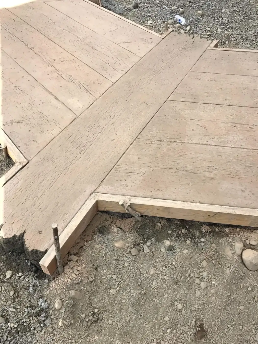 A detailed angle of the wooden formwork defining the junction of two walkway sections before the pour.