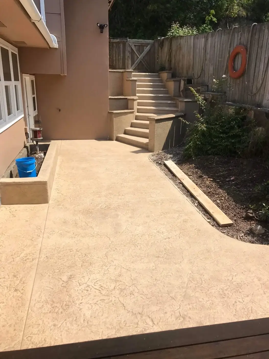 Stamped concrete patio and walkway leading to a multi-level staircase at a home in Puyallup, WA.
