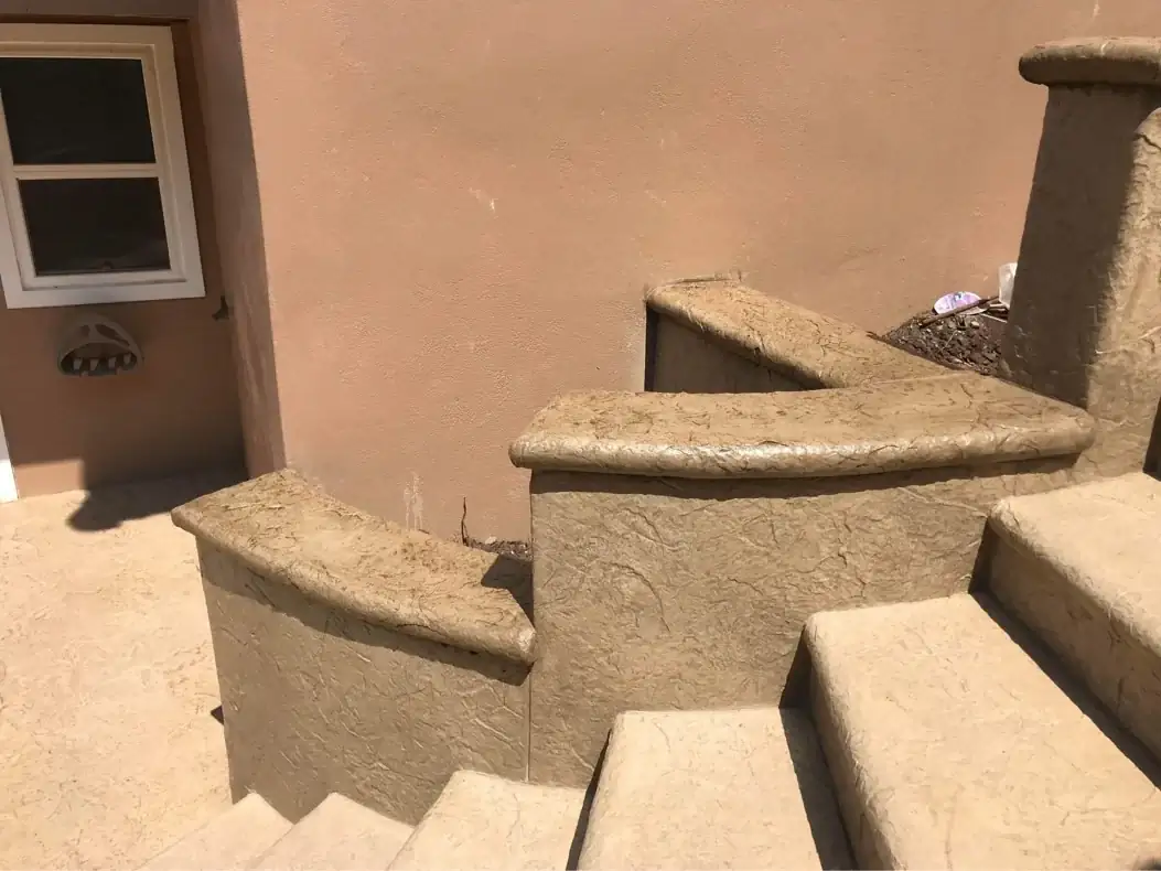 Detail of the sculpted, rounded coping on the stamped concrete retaining walls of a Puyallup staircase.