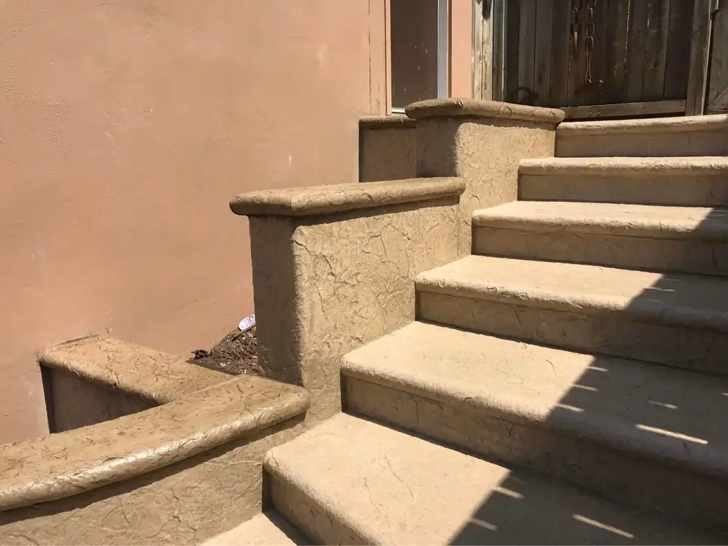 Side angle of the stamped concrete steps showing the consistent texture on treads and wall faces.