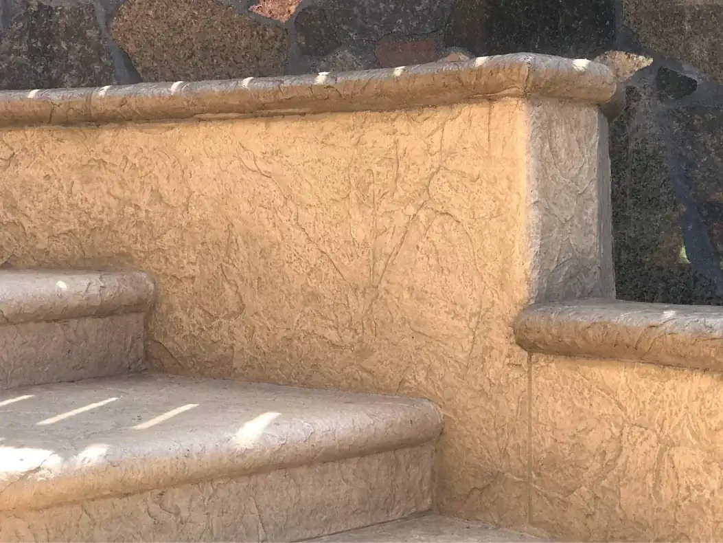 Close-up of the seamless slate texture on the retaining wall, showing color variation and depth.