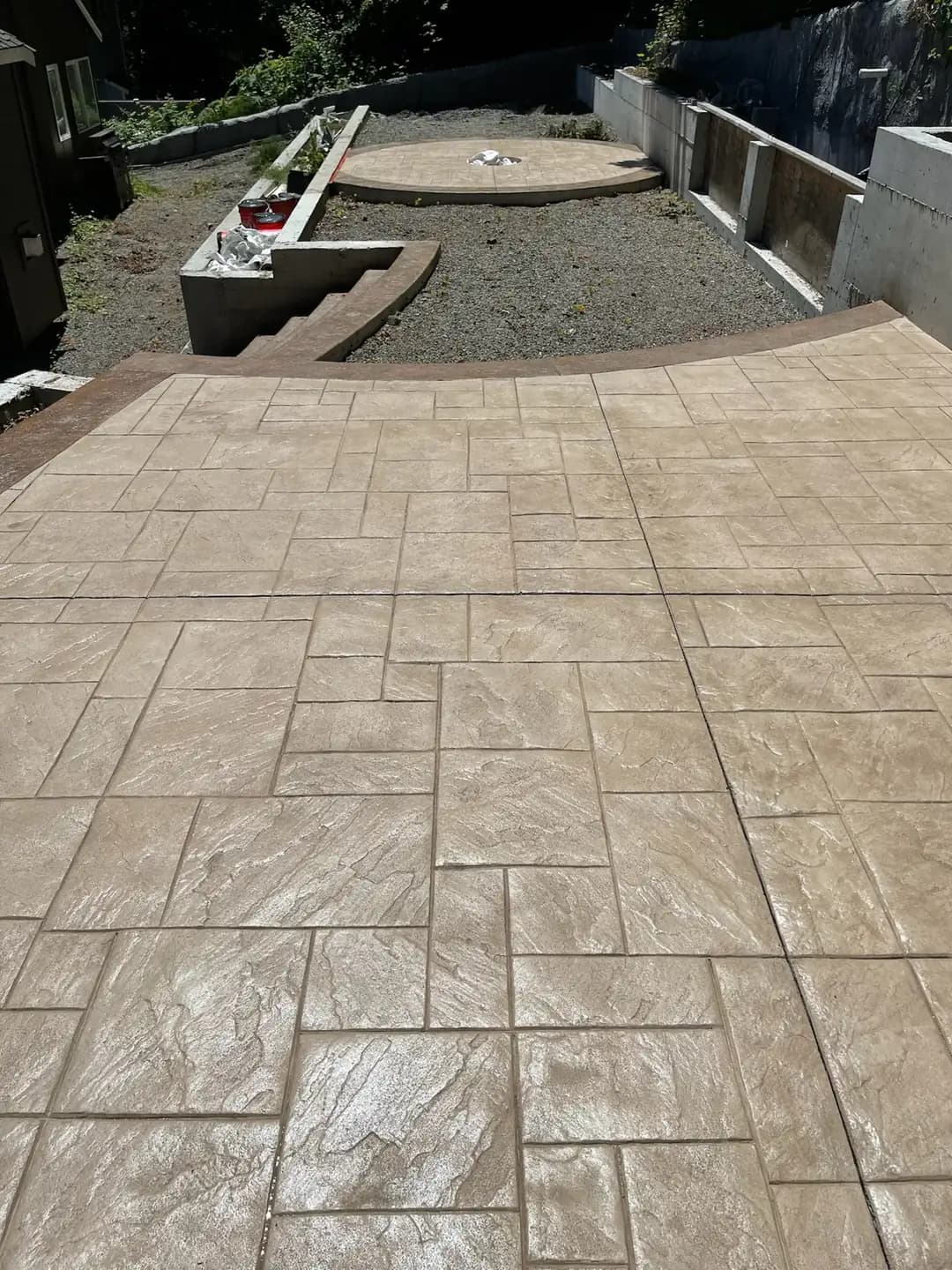High-angle view of a large ashlar slate stamped patio with integrated saw-cut control joints for durability.