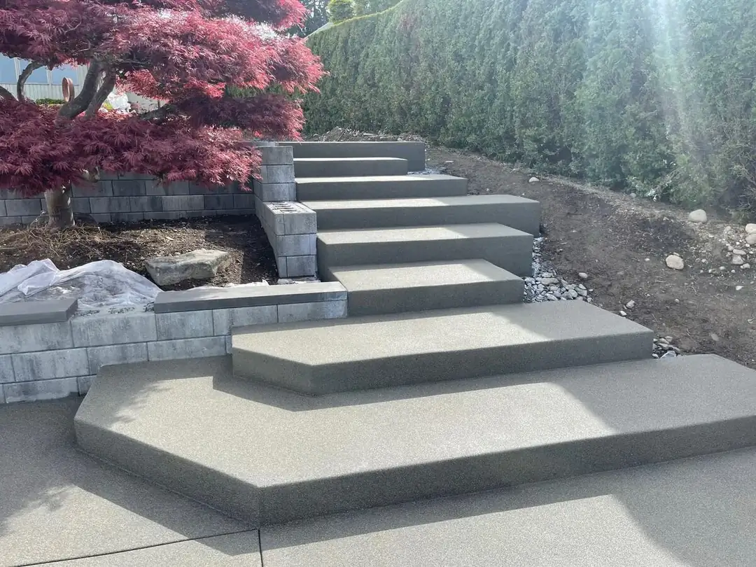 View from the bottom landing of a tiered concrete staircase with an exposed aggregate texture in Puyallup.