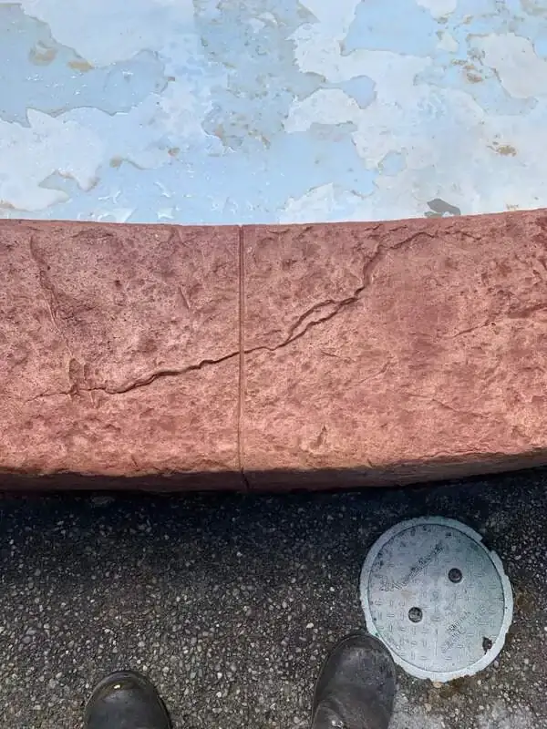 Close-up of the stamped concrete texture and a vertical control joint on the fountain wall in Enumclaw, WA.
