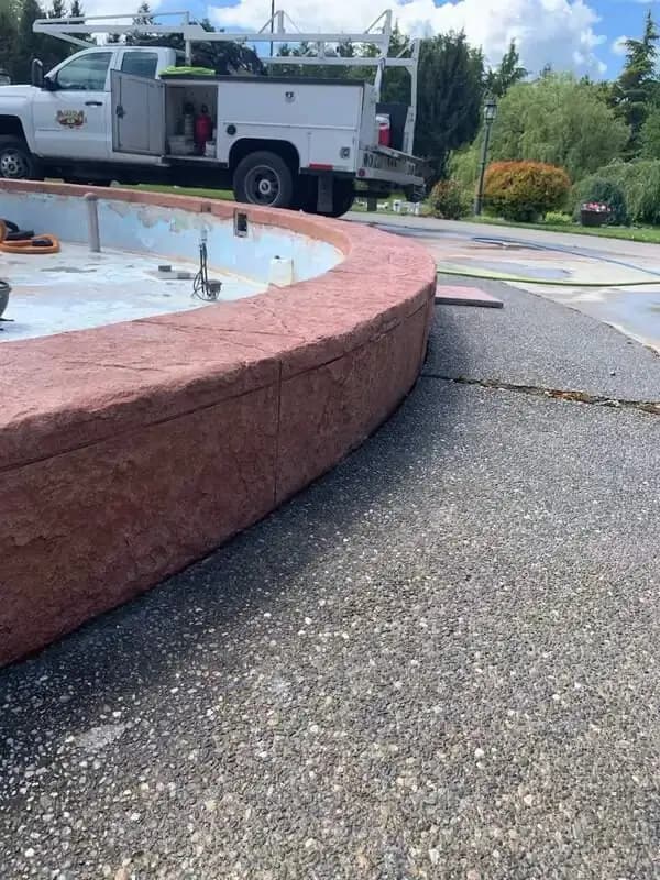 Side view showing the contrast between the stamped wall and the exposed aggregate pavement.