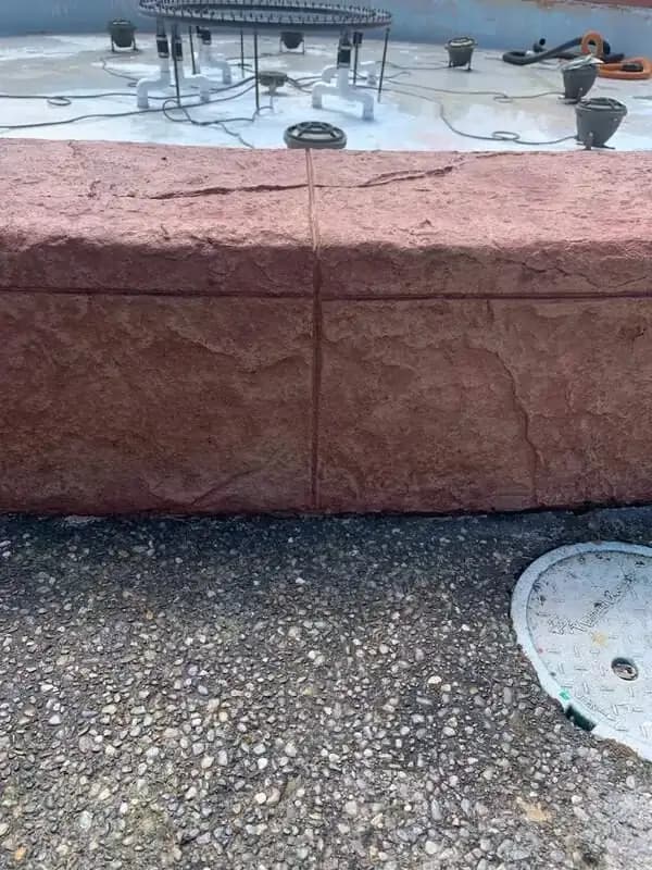 Front-facing detail of the stamped concrete wall sections and integrated control joints.