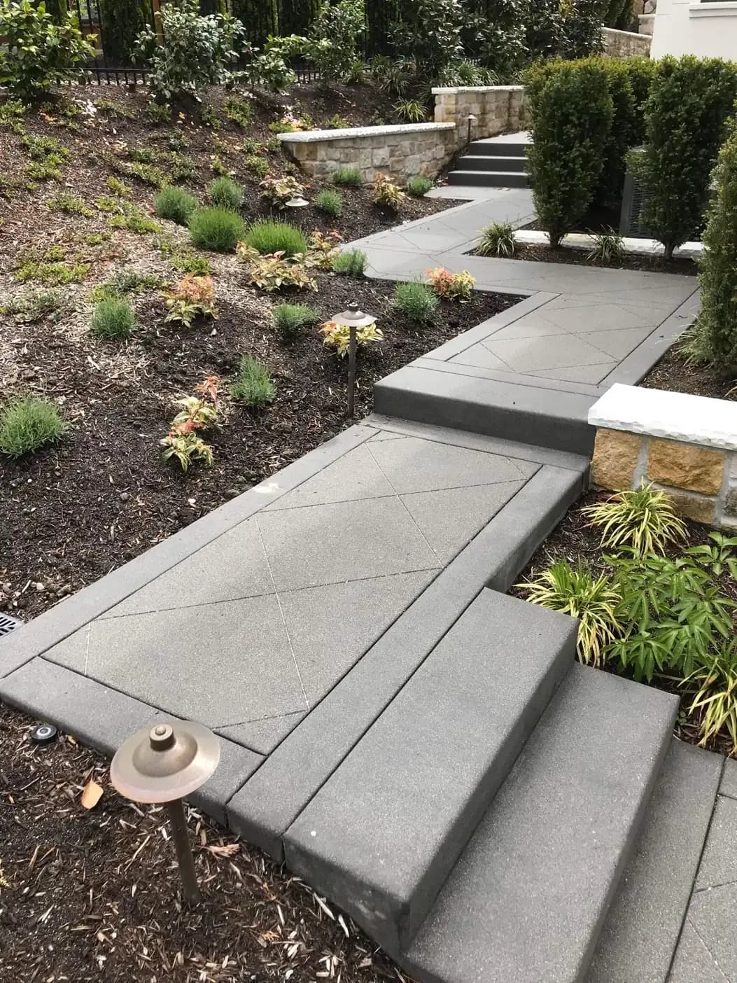 Angled view of the terraced concrete walkway showing the interplay of steps and landings with a uniform finish.