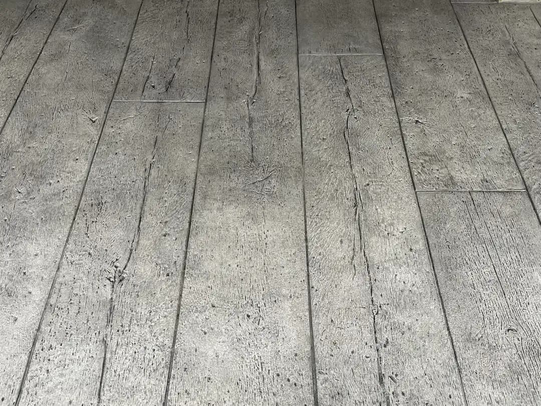 Overhead view highlighting the consistent color and texture of a wood plank stamped concrete installation.
